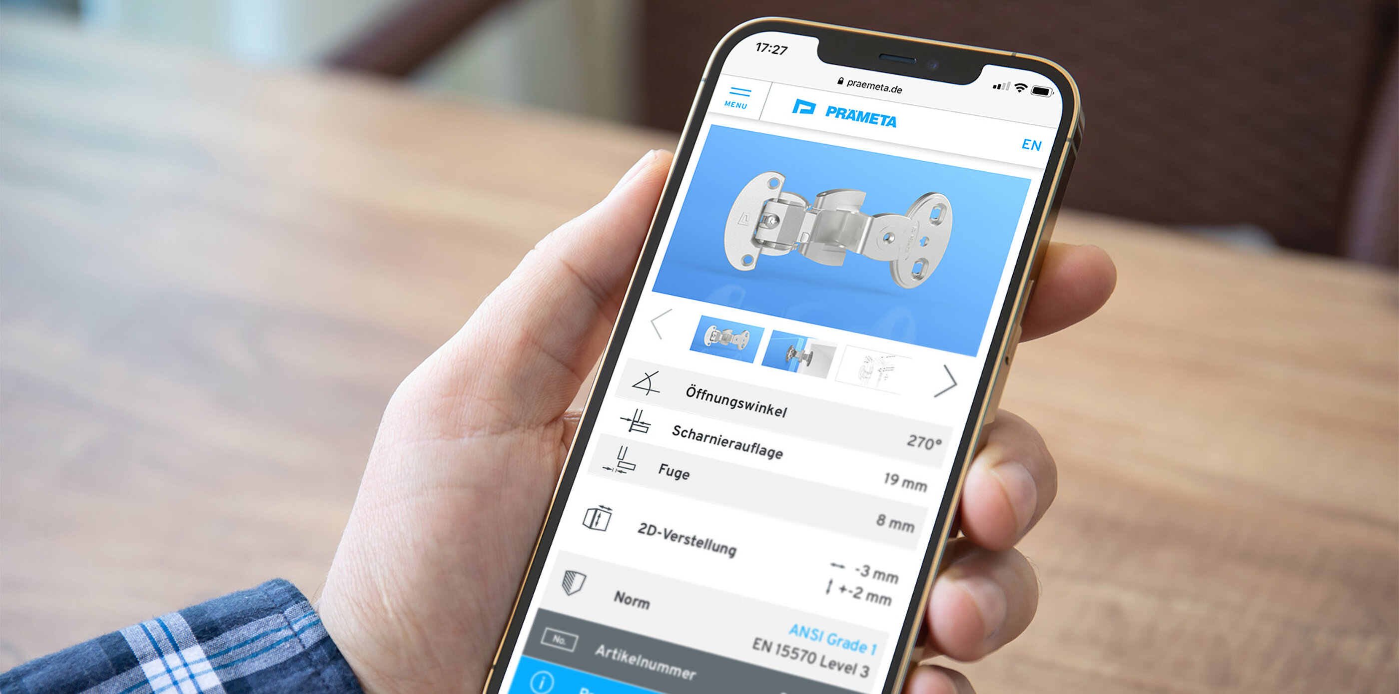 Eine positive User Experience erfüllt Nutzer-Bedürfnisse und zahlt auf das Marken-Image ein. Smartphone mit der Website des Scharnier Spezialisten PRÄMETA in der Hand eines Kunden.